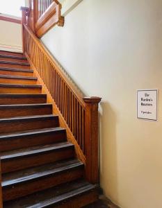 a staircase with a sign that reads the marias martins pharmacy at Wardens Quarters: 2 Bedroom Apt in Sault Ste. Marie +35 photos