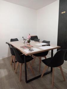 a dining room table with black chairs around it at Apartman TATTOO R LUX in Negotin +14 photos
