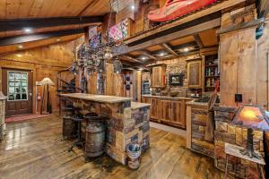 a kitchen with wooden walls and wooden floors at Big Bear Falls in Ellijay
