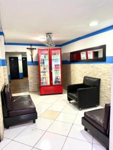 a waiting room with two soda machines and chairs at Hotel Sol y Luna 1 in Medellín