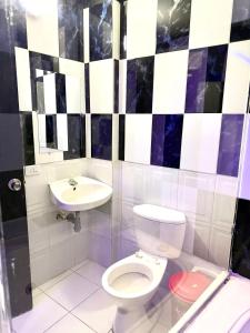 a bathroom with a toilet and a sink at Hotel Sol y Luna 1 in Medellín +5 photos