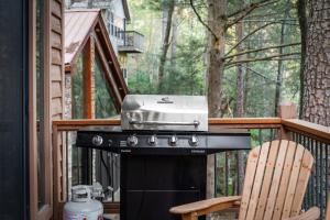 a grill on a deck next to a chair at Big Bear Falls in Ellijay