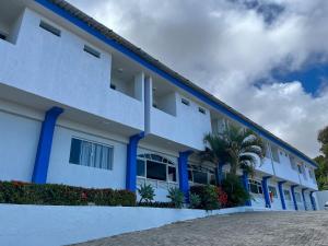a large white building with blue trim at El Aram Ponta Negra in Natal