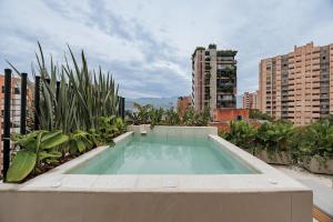 a swimming pool on the roof of a building at Lomm By Somos The Group in Medellín