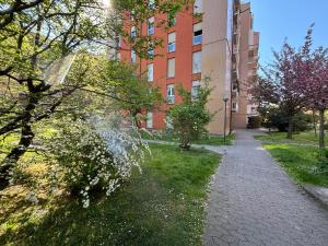 a walkway in front of a building with trees at Casa di Laura mono e bilo di fronte Ospedale San Raffaele in Segrate