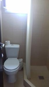 a bathroom with a white toilet and a light at Apartment Mixail in Agios Nikolaos