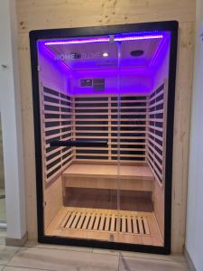 a display case with purple lights in a room at Ferienhaus Oberhüs - Das Familien-Ferienhaus an der Ostsee in Scharbeutz
