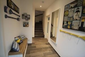 a hallway of a house with a staircase and a mirror at Ferienhaus Oberhüs - Das Familien-Ferienhaus an der Ostsee in Scharbeutz +6 photos