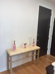 a table in a room with two bottles on it at Arthouse in Houston