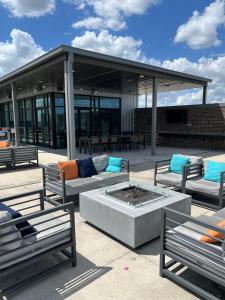 a patio with couches and a fire pit at Arthouse in Houston