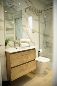a bathroom with a sink and a toilet and a shower at La CASA ROJA SOLARES in Solares +19 photos