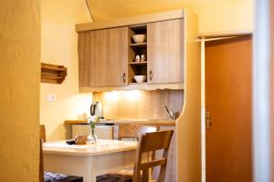 a small kitchen with a table in a room at Apartments Belopeški Dvori in Kranjska Gora