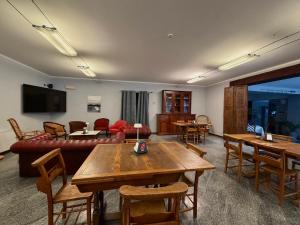a living room with a couch and a table at Hotel & Residence La Sibilla Cusiana in Pettenasco