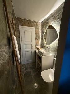 a bathroom with a white toilet and a sink at Helios stone house in Aegina +19 photos