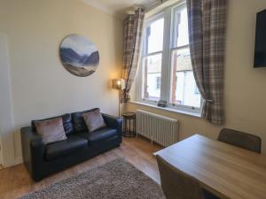 a living room with a couch and a table at St Johns View in Keswick