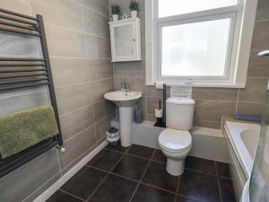 a bathroom with a toilet and a sink and a window at St Johns View in Keswick +16 photos