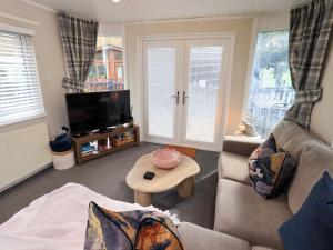 a living room with a couch and a table at Evermore Lodge in Windermere