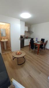a living room with a table and a kitchen at A Casa de Chelo in Palas de Rei +35 photos