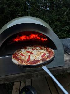a pizza is being cooked in an oven at Shepherd's Hut in Dorchester +12 photos
