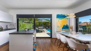 a kitchen and dining room with a table and chairs at Villa Angello in Matulji