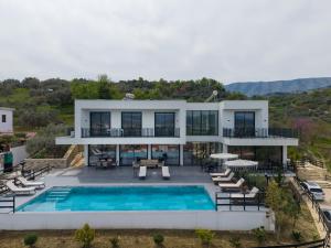 an aerial view of a house with a swimming pool at Vila Palma in Berat
