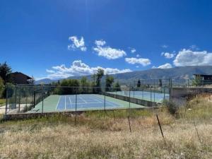 a tennis court in the middle of a field at Welcoming Wolf Getaway WL1405 Ski Escape Hot Tub in Eden