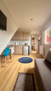 a living room with a couch and a kitchen at Apartamenty Ster Darłówko in Darlowko