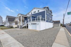 a large house with a garage on a gravel driveway at Prof Cleaned | Fast WiFi | BBQ | Linen & Towels in Seaside Heights