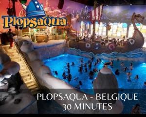a water slide at a water park with people in it at Cottage relaxant au bord de l'eau in Bourbourg