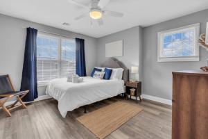 a bedroom with a bed and two windows at Prof Cleaned | Fast WiFi | BBQ | Linen & Towels in Seaside Heights