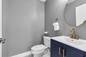a bathroom with a sink and a toilet and a mirror at Prof Cleaned | Fast WiFi | BBQ | Linen & Towels in Seaside Heights +8 photos