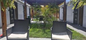 two chairs sitting on the side of a patio at Jardines Inn in Trinidad