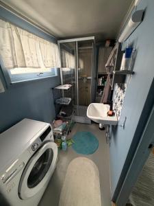 a small bathroom with a washing machine in it at Above The Arctic circle in Olderdalen