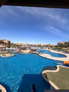 a view of a swimming pool at a resort at Family-Friendly Chalet at Piacera, Ain Sokhna in Ain Sokhna
