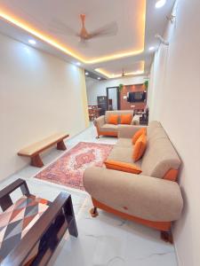 a living room with two couches and a table at Elegant villa getaway in Jaipur