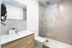 a bathroom with a toilet and a sink and a shower at AG Apartamentos BoiroBello 2 in Boiro