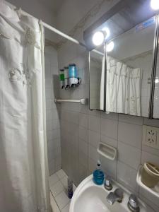 a bathroom with a shower and a sink and a mirror at Dulce Hogar in La Banda +42 photos