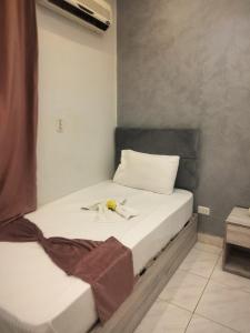 a bedroom with a bed with a flower on it at Sone Al Boos in Cairo