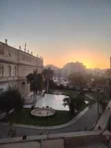a view of a city with a fountain in front of a building at Sone Al Boos in Cairo