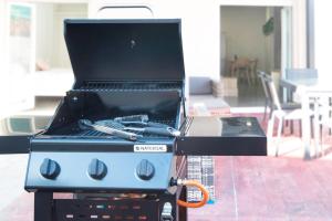 a bbq grill with a box on top of it at AG Apartamentos BoiroBello 2 in Boiro +1 photo