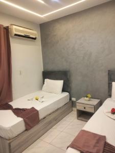 a bedroom with two beds and a air conditioner at Sone Al Boos in Cairo