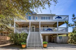 a house with white stairs and blue accents at 2020 - Merryweather in Sanderling +95 photos