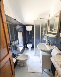 a bathroom with two sinks and a toilet in it at Borgo Maggiore in Radicofani +30 photos
