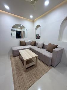 a living room with a couch and a table at Jacuzzi Escape Retreat in Kolshet
