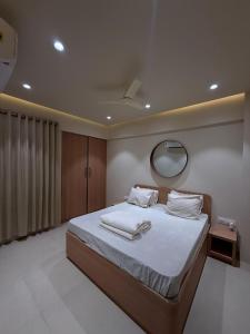 a bedroom with a large bed and a mirror at Jacuzzi Escape Retreat in Kolshet +9 photos