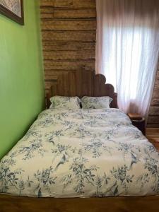 a bedroom with a bed with a blue and white comforter at Skansen in Vilnius