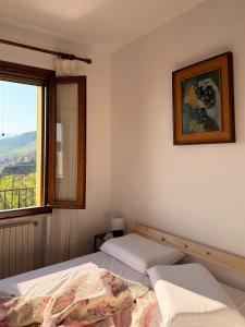 a bedroom with two beds and a window at Silvia Miotto's Guesthouse in Guia
