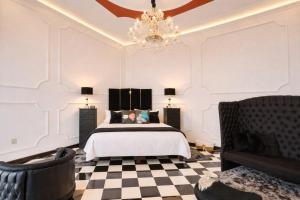 a bedroom with a bed and a chandelier at El Sueño Hotel & Spa in Puebla