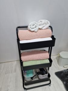 a stack of towels on a towel rack at Cabana Magia Apusenilor in Arada +43 photos