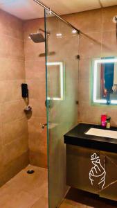 a bathroom with a shower and a sink at Omaxe Lucknow Luxury Home in Nalmatha